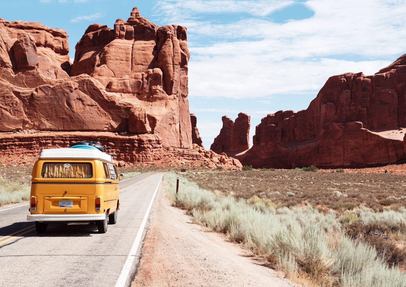 Open road travel scene through red rock landscape
